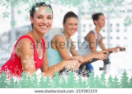 Composite image of snow frame against spinning class in gym