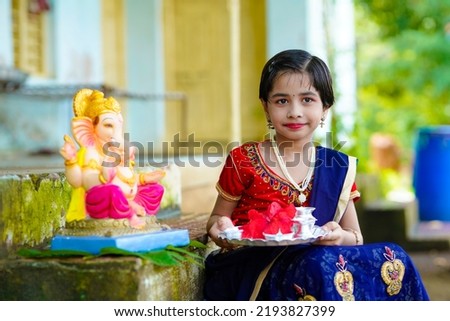 Cute indian little girl celebrating lord ganesha festival.