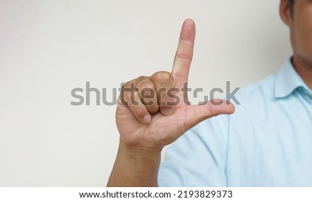 Closeup man shows hand sign gesture to communicate. Concept : Body sign Language to teach or communicate with deaf disabled. Education for handicaps .                              