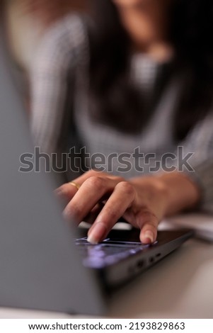 Young adult typing information on laptop, searching report and sending professional email. Using computer to search online data and browse internet network, taking notes and learning. Close up. Royalty-Free Stock Photo #2193829863