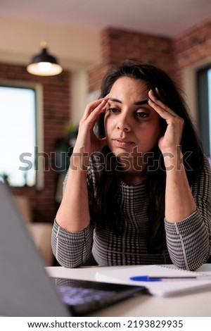Tired freelancer working from home and feeling stressed about overload and deadline, unhappy employee. Being exhausted and overworked, suffering from headache and burnout at remote job. Royalty-Free Stock Photo #2193829935