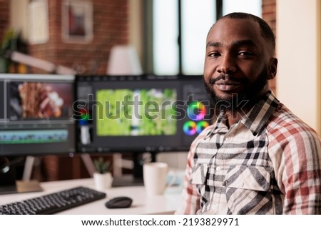 Portrait of freelancer working on video editing software to make film montage, creating movie footage for post production industry. Filming creator using multimedia panel to edit content.