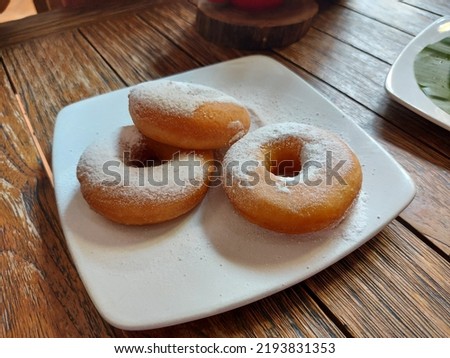 Donat salju. It is traditional donuts from indonesia. Made from flour dough and powdered sugar. Sweet and delicious.