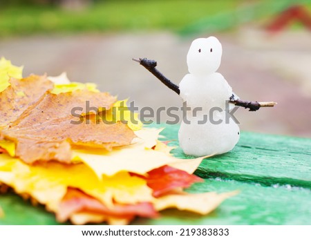Autumn cold snap. Winter snowman. first snow Royalty-Free Stock Photo #219383833