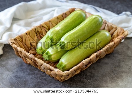 Organic zucchini. Fresh zucchini in basket on dark background. Vegetable, healthy vegan food. close up Royalty-Free Stock Photo #2193844765