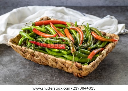 Hot peppers. Spice pepper in basket on dark background. Vegetable, healthy vegan food. close up