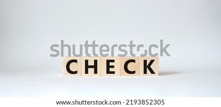 Check symbol. Wooden cubes with words Check. Beautiful white background. Check concept. Copy space.