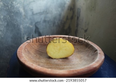 August 25, 2022, potato wedges placed on a brown wooden placemat, picture taken from the front side in the afternoon