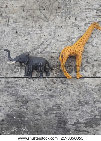 Wild animal toy on wooden background. Save the animal concept. Top view.