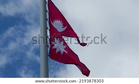 Nepal, flag is fluttering in the wind photo on the background of the sky, outdoors. National flag