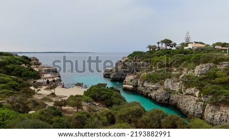 Cala en Brut beach, Menorca (Minorca), Spain. Lovely bay and beach Cala'n Brut. Popular place to jump into water from rock shelves Royalty-Free Stock Photo #2193882991