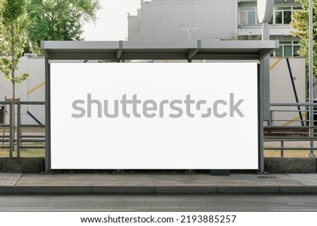 Large empty commercial banner mounted on urban bus stop front view outdoor Royalty-Free Stock Photo #2193885257