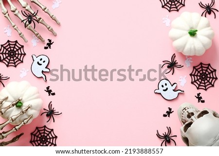 Pink Halloween background with cute decorations, ghosts, spiders, web, skull. Halloween holiday celebration concept. Halloween banner mockup, greeting card template.