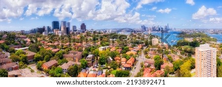 Aerial cityscape panorama from North Sydney to harbour and distant city CBD landmarks of Australia.