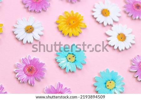 Pattern of colored flowers on pink background