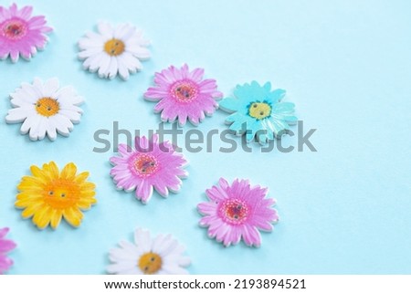 Pattern of wooden colored flowers on blue background