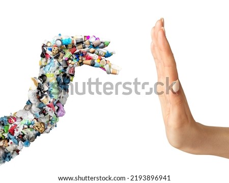 Pollution control concept. Human hand stops garbage in the shape of a hand on a white background Royalty-Free Stock Photo #2193896941