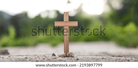 The cross of easter, resurrection concept. Christian wooden cross on a background with dramatic lighting. Copy space for your individual text.