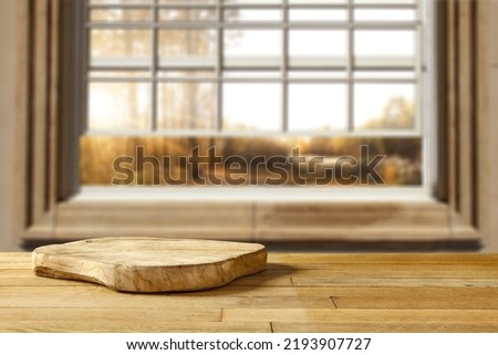 Table background of free space and autumn window. Home interior. 