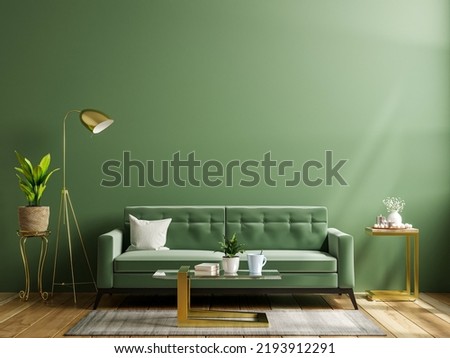 Luxury living room wall mockup with green sofa and decor on dark green background