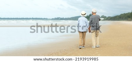 Asian Lifestyle senior couple walking chill on the beach happy in love romantic and relax time after retirement.  People tourism elderly family travel leisure and activity after retirement in vacation Royalty-Free Stock Photo #2193919985