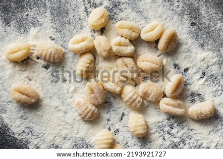Uncooked potato gnocchi on a kitchen table. Tasty italian food. Top view.