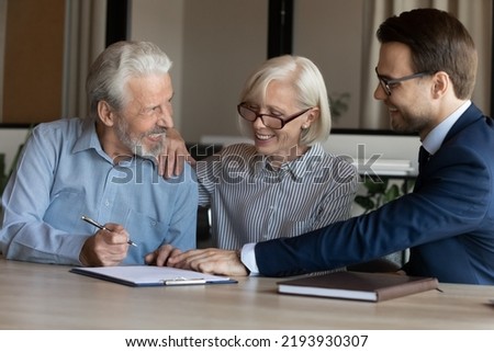 Excited mature couple signing contract with businessman manager realtor broker, making great investment or insurance deal at meeting, happy senior family purchasing real estate, taking loan