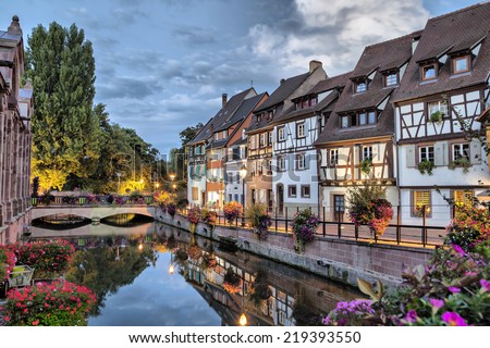 Colorful traditional french houses on the side of river Lauch at the evening in Colmar, France Royalty-Free Stock Photo #219393550