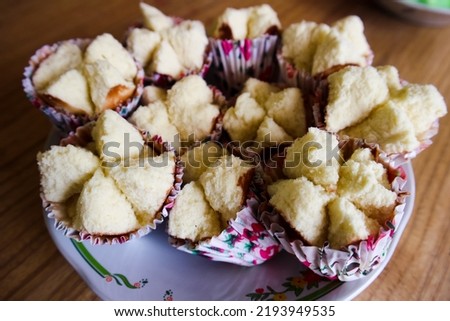 Kue Mangkok (Chinese fa gao) known as fortune cake, usually for Chinese New Year. Made from wheat flour and rice flour. Served in plate on wooden background. Selected focus image.