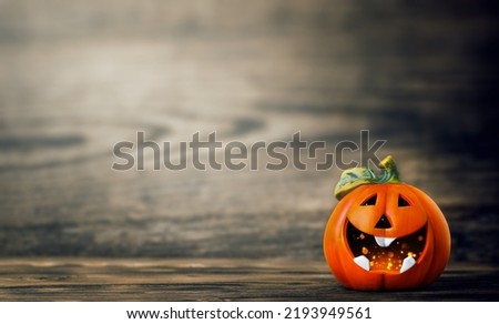 Pumpkin with a friendly smile on a wooden background, a place for text. Halloween Decor