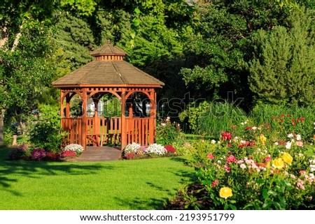 Cedar wooden gazebo at the rose garden in the city park of Penticton, British Columbia, Canada located in the Okanagan Valley. Royalty-Free Stock Photo #2193951799