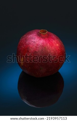 Still life with red pomegranat on the black background