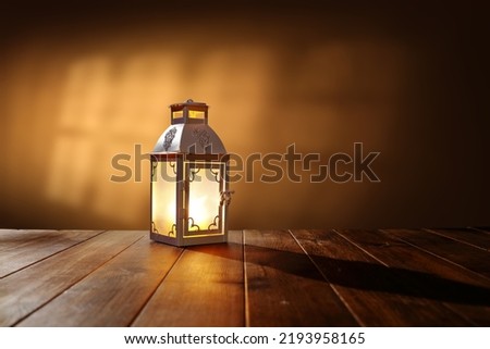 Lamp on table and wall with shadows. Autumn time. 