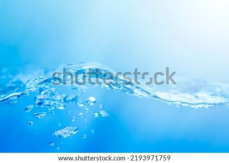blue and white smooth gradient with waves on the surface of clear water such as in the sea or fish tank background texture.