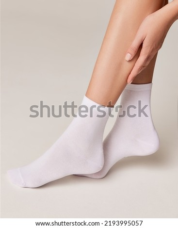 Woman wearing white socks for foot care Royalty-Free Stock Photo #2193995057