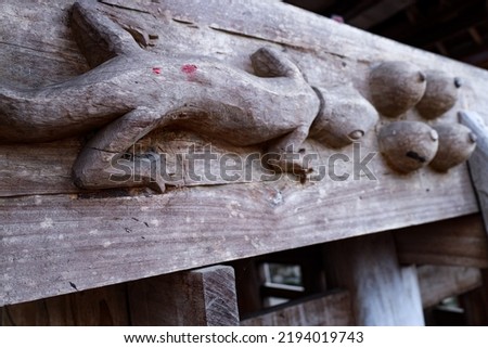 Lizard and breast ornaments in the traditional Batak house, Samosir