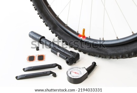 a set of tools for beading and repairing a bicycle wheel, on a white isolated background