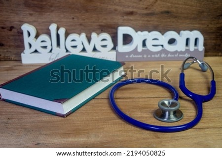Medical student textbooks and stethoscope on the table.