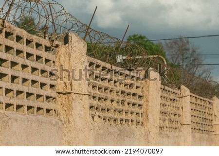 Barbed wire on the background of the sky close-up. Protected area, entrance is prohibited. Danger zone.