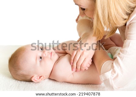 mother massaging her baby girl