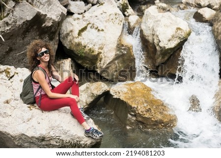 80's Style Mid Adult Curly Hair Smiling Woman in Natural Environment