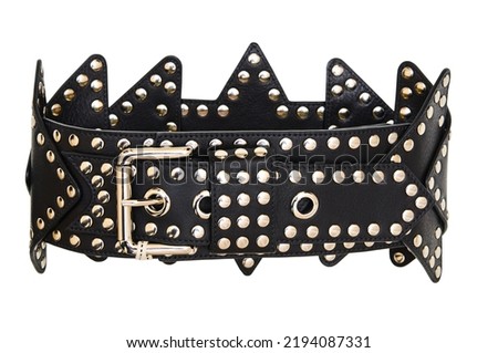 a black belt with a buckle and studs as a bright accessory for women's clothing, isolated on a white background, shot close-up