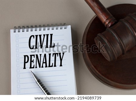 CIVIL PENALTY - words in white notebook on the background of the judge's hammer with stand