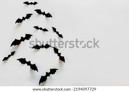 Bat silhouettes on the white wall with copy space. Minimalist Halloween decor