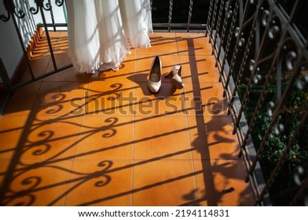 Wedding shoes and dress on the balcony.