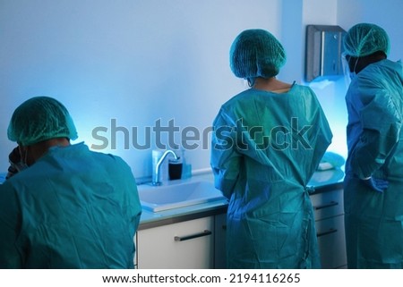 Medical workers in hazmat suit working with microscope inside modern laboratory hospital - Focus on nurse head