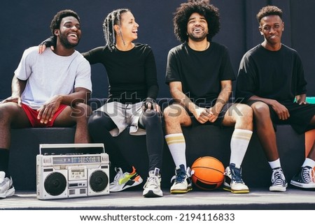 Group of young african people listening music outdoor after basketball match - Main focus on right guy face