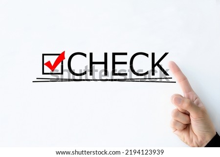 Human's hand pointing at "CHECK" word on whiteboard Royalty-Free Stock Photo #2194123939