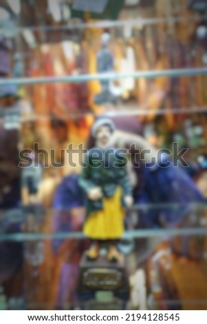 Defocused. Blur photo of someone trying to take a picture in glass.