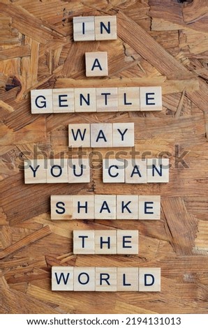 in a gentle way you can shake the world text on wooden square, business motivation quotes Royalty-Free Stock Photo #2194131013
